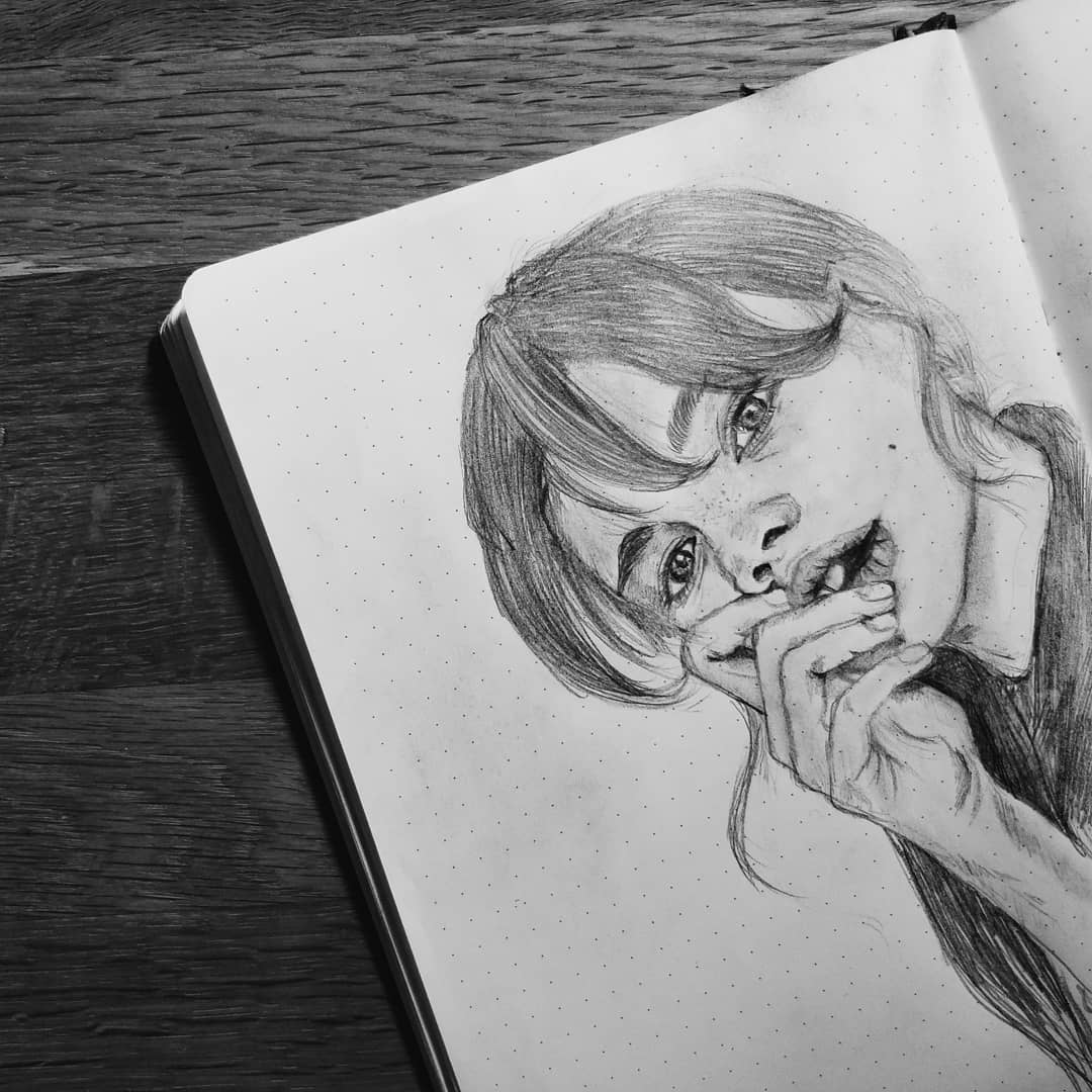 Pencil portrait drawing in a sketchbook